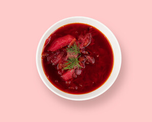Borsch. Beetroot soup in a white plate on a pink background. A traditional dish of Ukrainian cuisine. Top view.