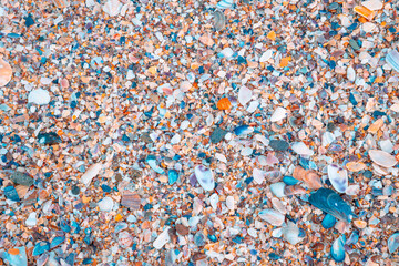 Shells, pebbles and stones on the beach from top view. Beach background photo