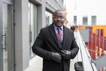 adult african man with glasses in black coat	
