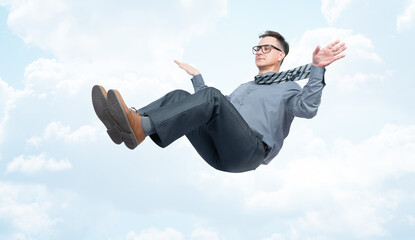 A happy man in a shirt, trousers, tie and glasses, arms outstretched, serenely flying in the sky....