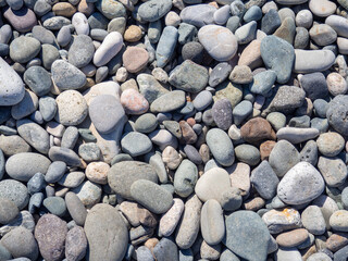 Pebbles on the beach. Background from stones.  Cobblestones on the beach.