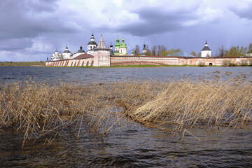 Fototapeta premium Beautiful landscape with a view of the ancient Orthodox monastery and the lake, cloudy weather