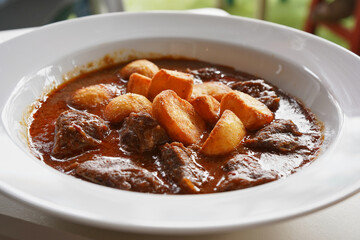 Beef stew with hot potatoes. Meat dish, cheeks