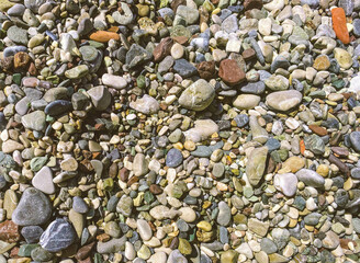 stones on the beach. pebble beach, seaside vacation, travel to a hot and warm country. texture with stones. 3d background, volumetric texture