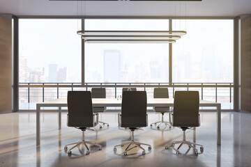 Big wooden conference table surrounded by black chairs on concrete glossy floor, stylish chandelier on top and city view from huge window in sunny meeting room. 3D rendering