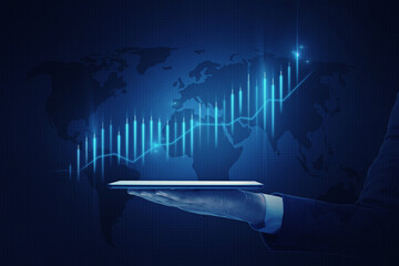 Global investing and stock market growth concept with digital financial chart raising candlestick on world map background projected from digital tablet on man hand