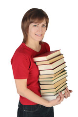 Happy girl holding in hands a pile of books.