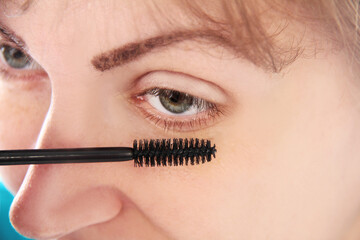 Woman eye with  eyelashes. Mascara Brush