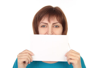 Fototapeta premium Smiling Woman Holding Empty White Poster Advertising Something Standing On Gray Studio Background. Mockup