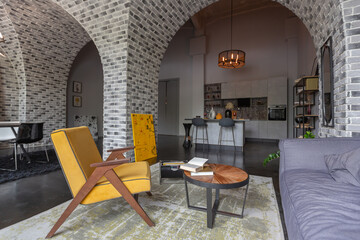 modern luxury design of a brutal apartment interior with arches in the style of a medieval castle with bright accents. free layout, kitchen area, seating and eating area.
