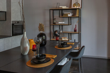 modern luxury design of a brutal apartment interior with arches in the style of a medieval castle with bright accents. close view of table setting with bright color elements