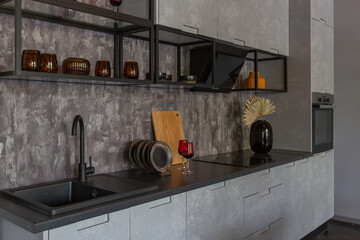 Fototapeta na wymiar modern luxury design of a brutal apartment interior with arches in the style of a medieval castle with bright accents. a stylish gray kitchen area with an island for cooking or spending time