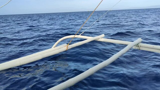 Video of a narrow-hulled boat stabilized by two outriggers; it is a traditional Filipino vessel, known locally as a Bangka or pump boat. Philippines