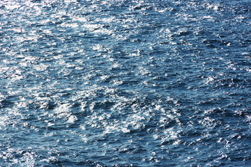 Sea water. Turquoise clear water. Summer background. Ocean dark blue water in sunny day. Tropical background