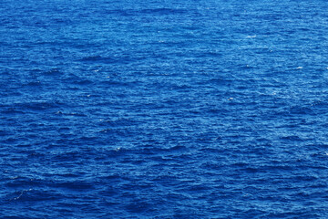 Sea water. Turquoise clear water. Summer background. Ocean dark blue water in sunny day. Tropical background