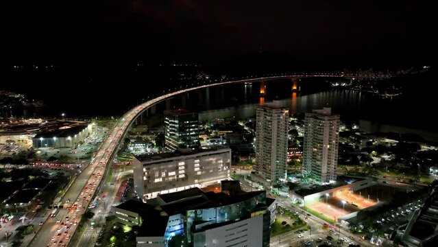 Night scape at famous third bridge at city of Vitória state of Espírito Santo Brazil. Corporate buildings at city. Night landscape of travel destination at town of Vitória Espírito Santo Brazil. 