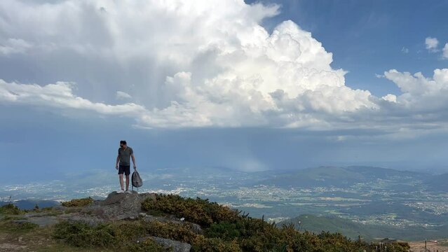 man standing on a mountain view from the highest mountain in Portugal video Atlantic Ocean and the sun is shining. High quality photo