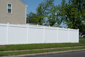 Fototapeta na wymiar White vinyl fence fencing of private property