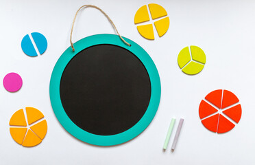 Set of charts on white background. School blackboard and wooden math fractions on the table. Back...