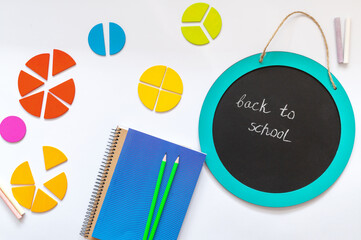 Set of charts on white background. School blackboard and wooden math fractions on the table. Back...