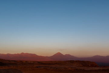 Fototapeta na wymiar Sunset at the Moon Valley (Valle de la Luna) with the Licancabur volcano, Atacama, Chile, South America