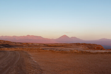 Fototapeta na wymiar Sunset at the Moon Valley (Valle de la Luna) with the Licancabur volcano, Atacama, Chile, South America