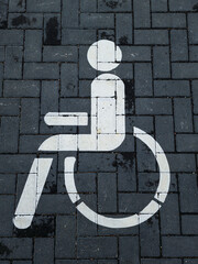 International handicapped symbol painted on a parking space.