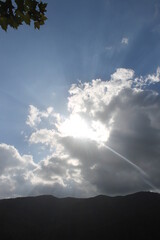 Sunbeam through mist in blue sky - can be used as background and look dramatic and enigmatic.