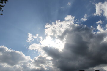 Sunbeam through mist in blue sky - can be used as background and look dramatic and enigmatic.