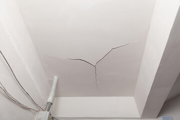 Crack in the ceiling. Surface paint and stucco are damaged. Hack repair, poor painting of ceiling...
