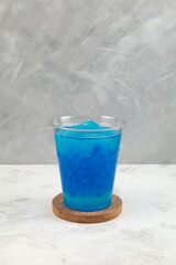 Blue Crushed ice or snow slush with tapioca pearls in disposable plastic cup. Bubble tea....
