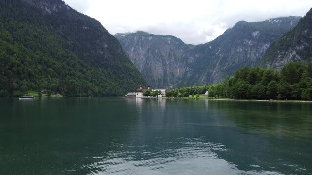Church on the edge of lake konigssee, low flying drone dolly shot