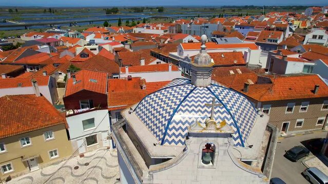 Circle Aerial view of the dome of Capela De Sao Goncalo against the Typical Portugal old houses rooftops in Aveiro city. Portugal