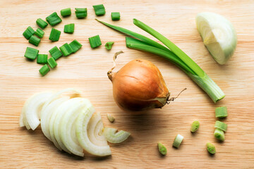 Onions on a wooden cutting board.