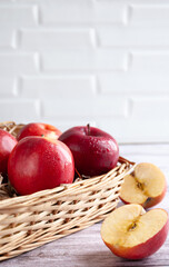 Fresh red apples isolated in basket under bright sunlight. Fresh natursl product. Harvest of apples. Food. Close up Selective focus