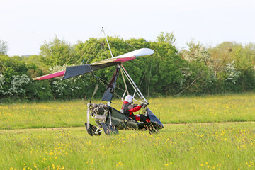 Ultralight airplane taxiing on a farm strip	
