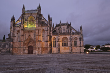the Facade of the Main Entrance at the Batalha Monastery at night, Portugal