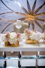 Bouquets of flowers in vase on the wedding table