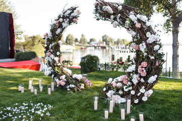 Arch for an outdoor wedding ceremony with candles