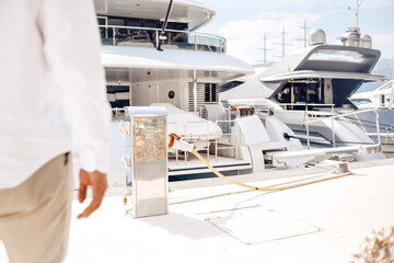 Men's hands refuel their yacht. Fuel station for yachts and boats.
