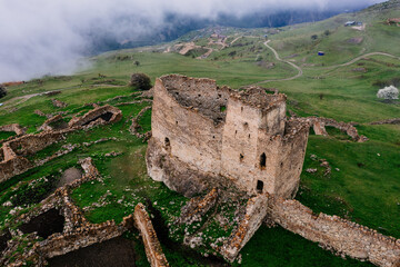 Old ruined castle Frigate in the misty mountains, aerial view