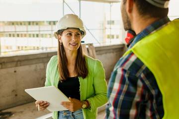 Architect and foreman meeting at construction site,Architect inspects the construction site,Construction project concept.