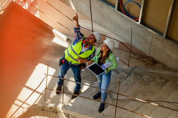 Architect and foreman meeting at construction site,Architect inspects the construction site,Construction project concept.