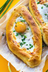 Adjarian khachapuri on the table with egg yolk 