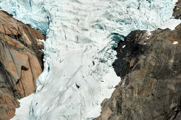 Naklejka premium Briksdalsbre glacier. Late afternoon. Fast stream. Glacier waterfall. Spring in Norway. Jostedalsbreen National Park.