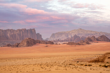 Red sands, mountains, dramatic sky and marthian landscape panorama of Wadi Rum desert, Jordan
