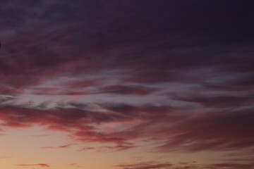 Beautiful violet sunset and purple clouds over the night city.