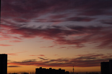 Beautiful violet sunset and purple clouds over the night city.