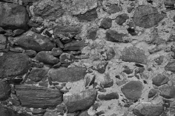 gray background, in the photo an old stone wall made of large stones