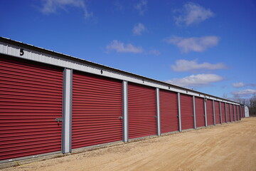 Fototapeta na wymiar Red storage unit buildings site outside of Fond du Lac, Wisconsin holding owers property.